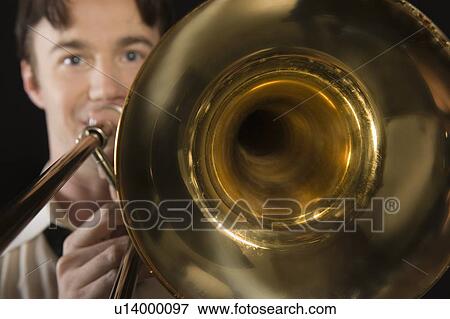 Mid-adult man with open-collar shirt plays the trombone View Large Photo Image Stock Photo - Mid-adult man with open-collar shirt plays the trombone. Fotosearch