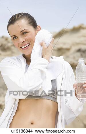 Mid adult woman after exercise View Large Photo Image Picture - Mid adult woman after exercise. Fotosearch