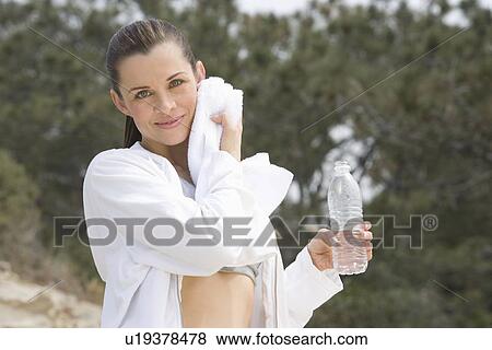 Stock Photo - Mid adult woman after exercise. Fotosearch