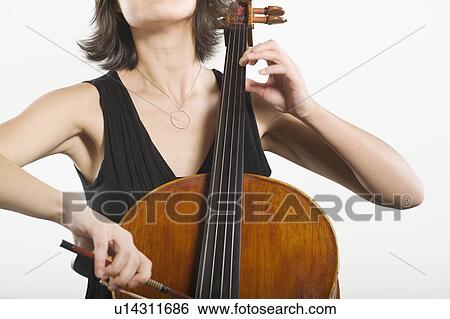 Stock Photograph - Mid section of female cellist. Fotosearch