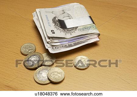 Stock Photograph - Money clip with banknotes and coins. Fotosearch