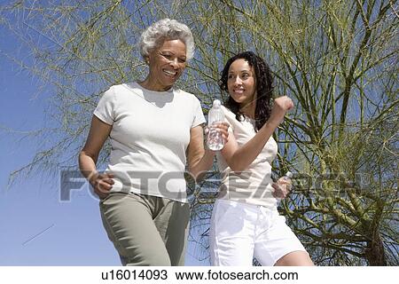 Mother and daughter jog together View Large Photo Image Stock Image - Mother and daughter jog together. Fotosearch