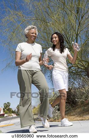 Mother and daughter jog together View Large Photo Image Stock Image - Mother and daughter jog together. Fotosearch