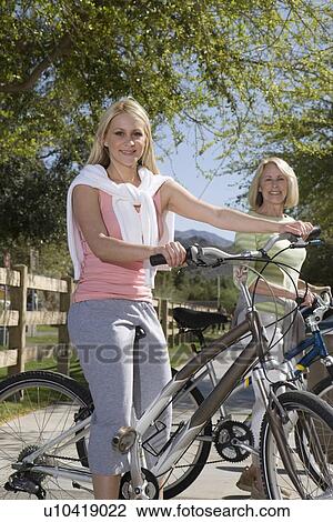 Mother and daughter with mountain bikes View Large Photo Image Stock Image - Mother and daughter with mountain bikes. Fotosearch
