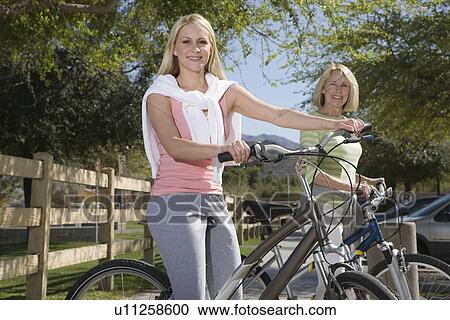 Mother and daughter with mountain bikes View Large Photo Image Stock Image - Mother and daughter with mountain bikes. Fotosearch