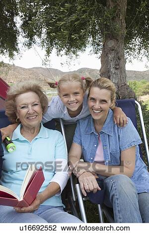 Stock Image - Mother, daughter and grand-daughter, portrait outside tent. Fotosearch