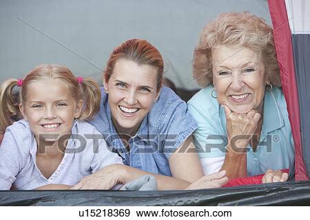 Mother, daughter and grand-daughter smiling from tent View Large Photo Image Stock Photo - Mother, daughter and grand-daughter smiling from tent. Fotosearch