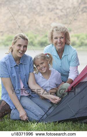 Mother, daughter and grand-daughter putting up a tent View Large Photo Image Stock Photograph - Mother, daughter and grand-daughter putting up a tent. Fotosearch