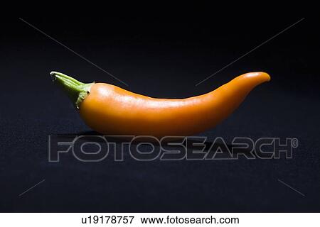 Orange chilli pepper View Large Photo Image Stock Photo - Orange chilli pepper. Fotosearch