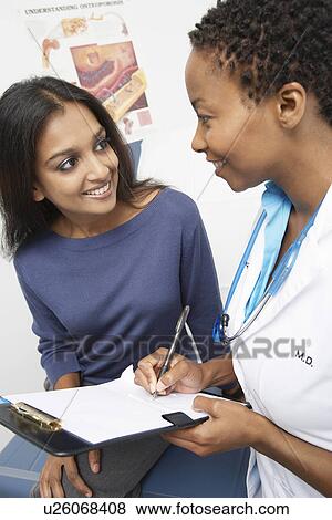 Patient and female doctor smiling View Large Photo Image Stock Photo - Patient and female doctor smiling. Fotosearch