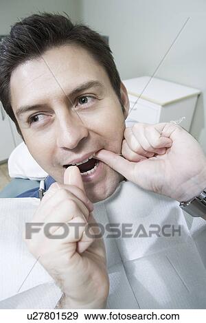 Stock Photo - Patient with fingers in mouth. Fotosearch