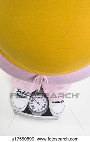 Person standing on bathroom scale, low section View Large Photo Image Stock Image - Person standing on bathroom scale, low section. Fotosearch