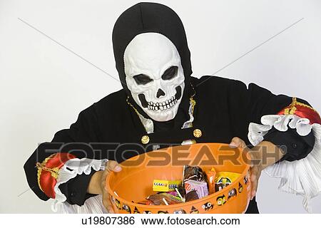 Portrait of boy (7-9) wearing skeleton mask, holding candy bowl View Large Photo Image Stock Photograph - Portrait of boy (7-9) wearing skeleton mask, holding candy bowl. Fotosearch