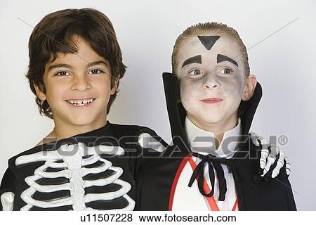 Portrait of boys (7-9) wearing Halloween costumes View Large Photo Image Stock Photo - Portrait of boys (7-9) wearing Halloween costumes. Fotosearch
