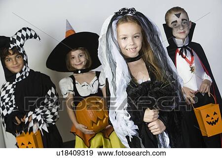 Portrait of boys and girls (7-9) wearing Halloween costumes View Large Photo Image Stock Photo - Portrait of boys and girls (7-9) wearing Halloween costumes. Fotosearch