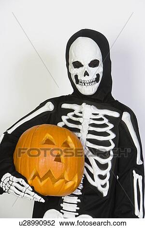 Portrait of child (7-9) wearing skeleton costume, with jack-o-lantern View Large Photo Image Stock Image - Portrait of child (7-9) wearing skeleton costume, with jack-o-lantern. Fotosearch