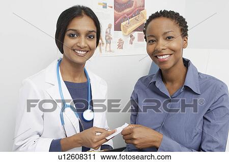 Portrait of female doctor and patient smiling View Large Photo Image Stock Image - Portrait of female doctor and patient smiling. Fotosearch