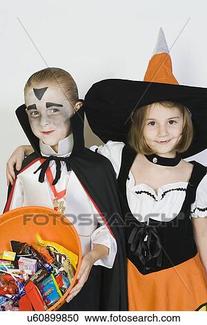 Portrait of girl embracing boy (7-9), wearing Halloween costumes View Large Photo Image Stock Image - Portrait of girl embracing boy (7-9), wearing Halloween costumes. Fotosearch