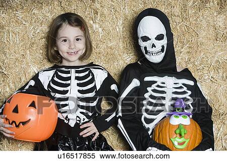 Portrait of girls (7-9) wearing skeleton costumes, with jack-o-lanterns View Large Photo Image Stock Photography - Portrait of girls (7-9) wearing skeleton costumes, with jack-o-lanterns. Fotosearch
