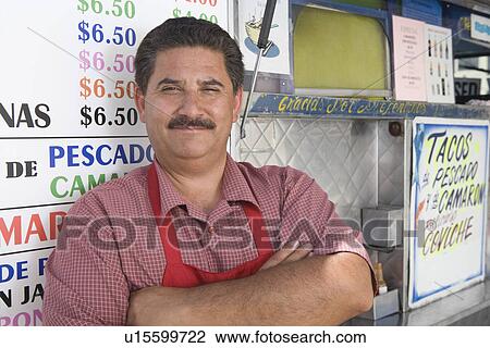 Stock Image - Portrait of man outside cafe. Fotosearch