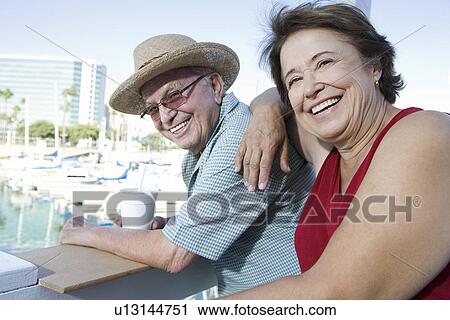 Portrait of senior couple on holidays, smiling View Large Photo Image Stock Image - Portrait of senior couple on holidays, smiling. Fotosearch