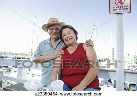 Portrait of senior couple on vacations, smiling View Large Photo Image Picture - Portrait of senior couple on vacations, smiling. Fotosearch