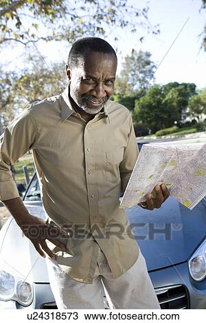 Portrait of senior man holding map View Large Photo Image Stock Image - Portrait of senior man holding map. Fotosearch