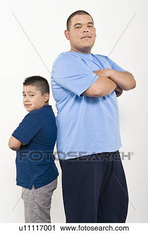 Stock Image - Portrait of teenage (16-17) and pre-teen (10-12) boy. Fotosearch