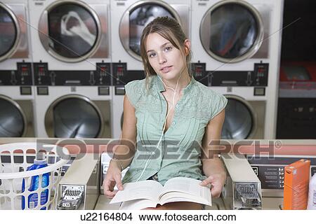 Portrait of young woman at launderette View Large Photo Image Picture - Portrait of young woman at launderette. Fotosearch