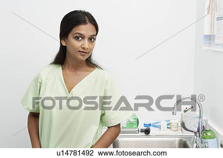 Portrait of young woman, disinfection sink in backgound View Large Photo Image Stock Image - Portrait of young woman, disinfection sink in backgound. Fotosearch