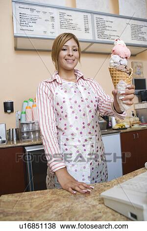 Portrait of young woman serving ice cream View Large Photo Image Stock Photo - Portrait of young woman serving ice cream. Fotosearch