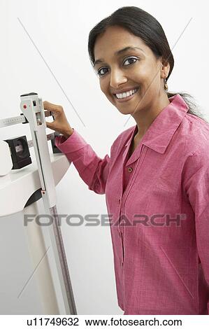 Portrait of young woman with scales View Large Photo Image Stock Image - Portrait of young woman with scales. Fotosearch