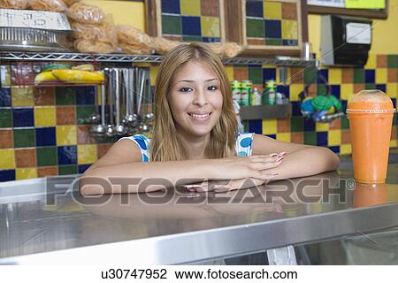 Portrait of young woman working in diner View Large Photo Image Stock Image - Portrait of young woman working in diner. Fotosearch