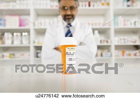 Prescription drugs and male pharmacist View Large Photo Image Stock Image - Prescription drugs and male pharmacist. Fotosearch
