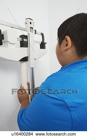 Rear view of boy with scales View Large Photo Image Picture - Rear view of boy with scales. Fotosearch