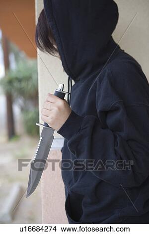 Robber with knife hiding behind corner View Large Photo Image Picture - Robber with knife hiding behind corner. Fotosearch