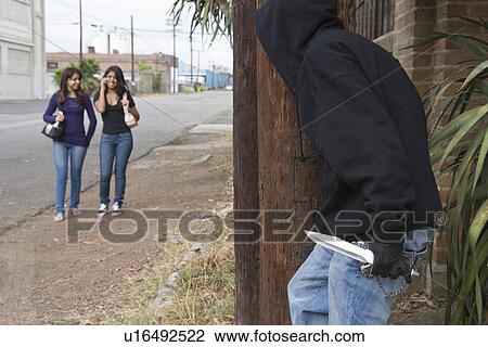 Robber with knife hiding behind tree and waiting for two girls View Large Photo Image Stock Image - Robber with knife hiding behind tree and waiting for two girls. Fotosearch