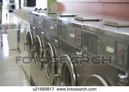 Row of washing machines in launderette View Large Photo Image Stock Photo - Row of washing machines in launderette. Fotosearch
