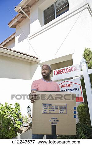 Sad mid adult man moving out of house View Large Photo Image Stock Photo - Sad mid adult man moving out of house. Fotosearch