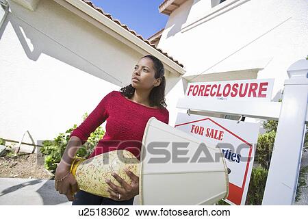 Sad mid adult woman moving out of house View Large Photo Image Stock Image - Sad mid adult woman moving out of house. Fotosearch