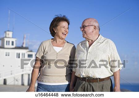 Stock Photo - Senior couple looking in eyes, smiling. Fotosearch