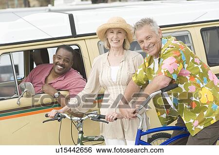 Senior couple stand with bikes next to campervan driven by mature man View Large Photo Image Stock Photograph - Senior couple stand with bikes next to campervan driven by mature man. Fotosearch