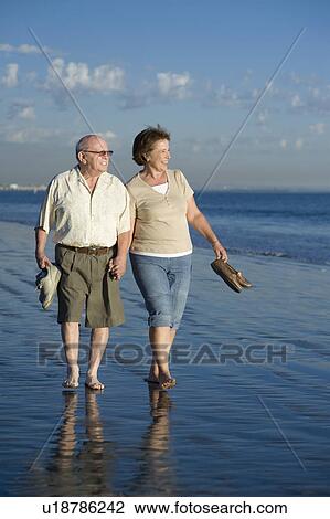 Senior couple walking on beach View Large Photo Image Stock Image - Senior couple walking on beach. Fotosearch