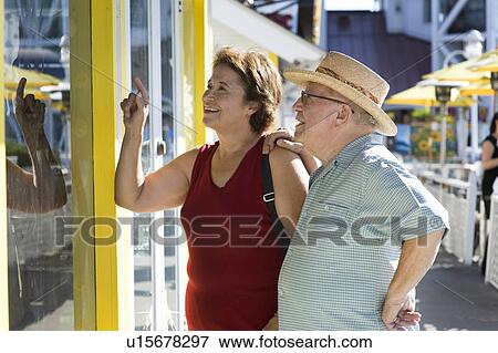 Senior couple watching shop window View Large Photo Image Stock Photo - Senior couple watching shop window. Fotosearch