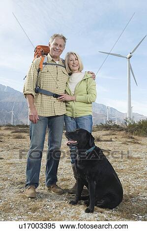 Senior couple with dog near wind farm View Large Photo Image Stock Photography - Senior couple with dog near wind farm. Fotosearch