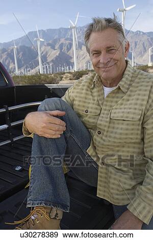 Stock Photo - Senior man near wind farm, portrait. Fotosearch