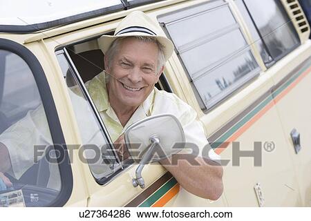 Senior man sits in drivers seat of campervan leaning through window View Large Photo Image Stock Photograph - Senior man sits in drivers seat of campervan leaning through window. Fotosearch