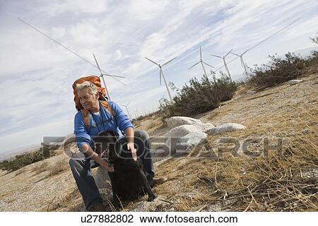 Senior man with backpack near wind farm View Large Photo Image Stock Image - Senior man with backpack near wind farm. Fotosearch