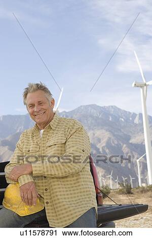 Senior man working at wind farm View Large Photo Image Stock Image - Senior man working at wind farm. Fotosearch