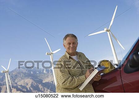 Senior man working at wind farm View Large Photo Image Stock Image - Senior man working at wind farm. Fotosearch